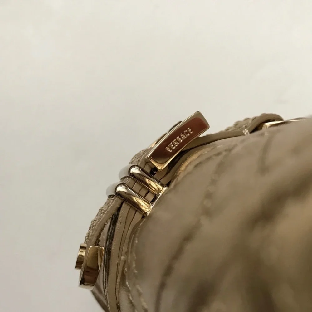 Hold Versace gold quilted handbag